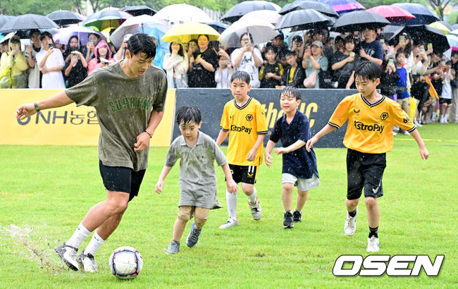 [OSEN=부천, 최규한 기자] 22일 오후 경기도 부천시청 잔디광장에서 ‘2024 황희찬 풋볼 페스티벌’이 열렸다.이번 행사는 황희찬의 축구용품 전시회, 풋볼 페스티벌, 팬 미팅, 멘토링 시간 등으로 구성된다. 황희찬은 팬 미팅 수익금 전액을 기부할 예정이다. 황희찬(28, 울버햄튼)이 어린이들과 함께 풋살 경기를 펼치고 있다. 2024.06.22 / dreamer@osen.co.kr