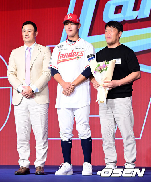 [OSEN=지형준 기자] 11일 오후 서울 잠실 롯데호텔 월드에서 2025 KBO 신인 드래프트가 열렸다.2025 KBO 신인 드래프트는 전면 드래프트 방식으로 진행된다. 지명은 1라운드부터 11라운드까지 이뤄지며, 2023년도 구단 순위의 역순인 키움-한화-삼성-롯데-KIA-두산-NC-SSG-KT-LG 순서로 실시된다.강릉고 포수 이율예가 SSG에 1라운드 지명되며 김재현 단장, 아버지와 포즈를 취하고 있다. 2024.09.11 / jpnews@osen.co.kr