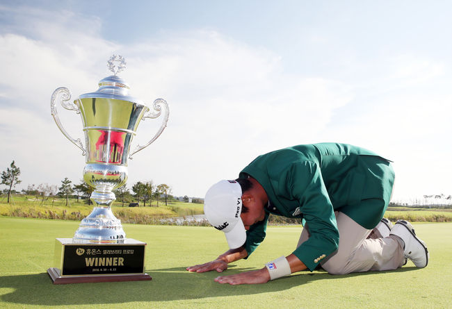지난 해 휴온스 대회에서 데뷔 9년만에 첫 우승을 거둔 뒤 트로피에 큰 절을 하고 있는 엄재웅.