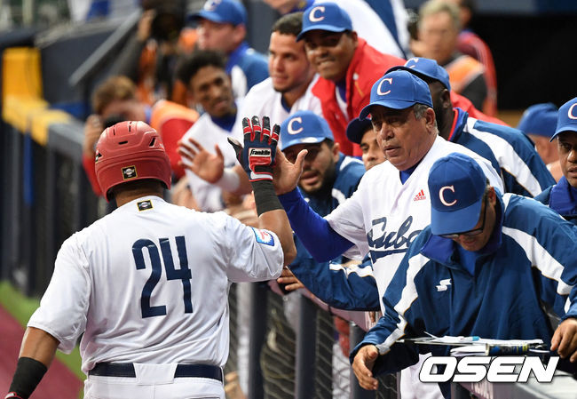 7일 오후 서울 고척스카이돔에서 '2019 세계야구소프트볼연맹(WBSC) 프리미어12' 예선 C조 호주와 쿠바 경기가 열렸다.5회말 쿠바 요르다니스 자몬의 선제 적시타 때 홈을 밟은 프레데릭 세페다가 더그아웃에서 동료들의 축하를 받고 있다. /sunday@osen.co.kr