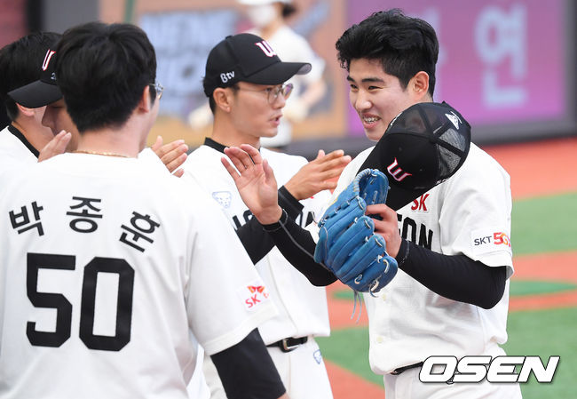 6회초 SK 김정빈 투수가 삼자범퇴로 이닝종료 한뒤 동료들의 축하를 받으며 더그아웃으로 들어가고 있다 /   soul1014@osen.co.kr