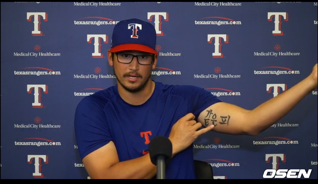 텍사스의 데인 더닝이 13일(한국시간) 화상 인터뷰 중 자신의 왼팔에 새겨진 문신을 보여주고 있다. <텍사스 레인저스 구단 제공 동영상 캡처>