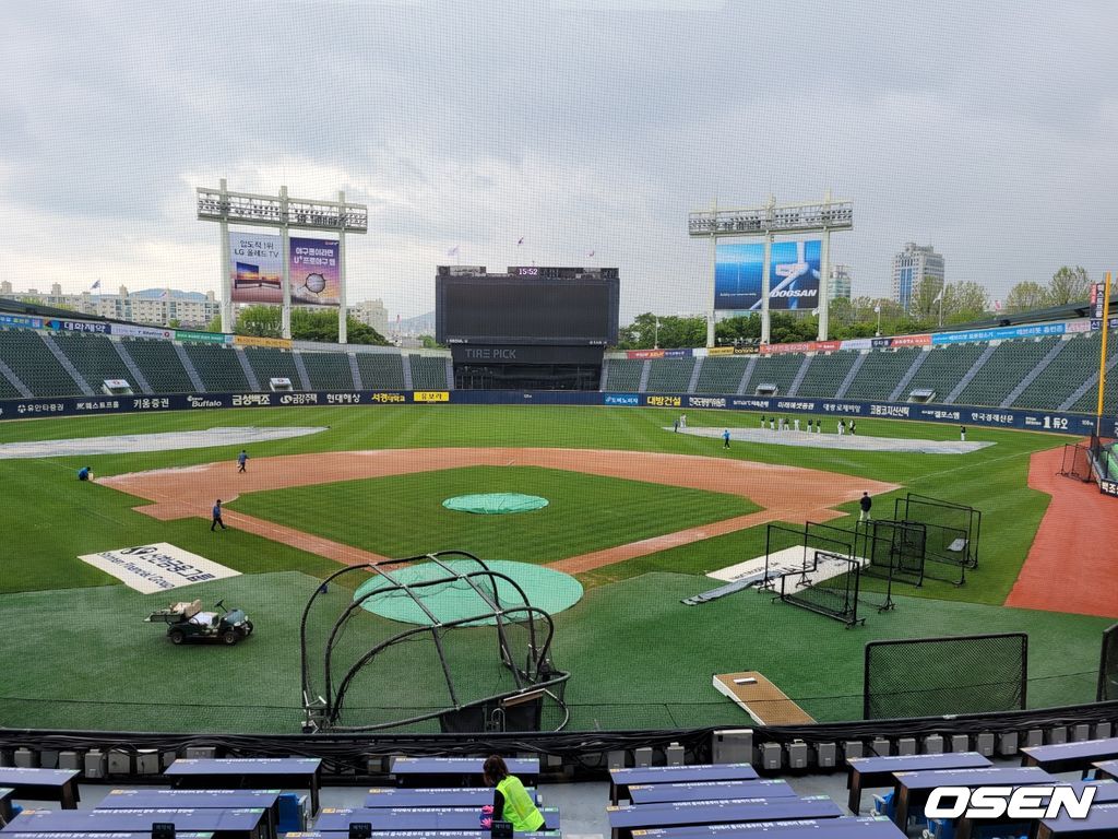 방수포 치우고 있는 잠실구장. /knightjisu@osen.co.kr