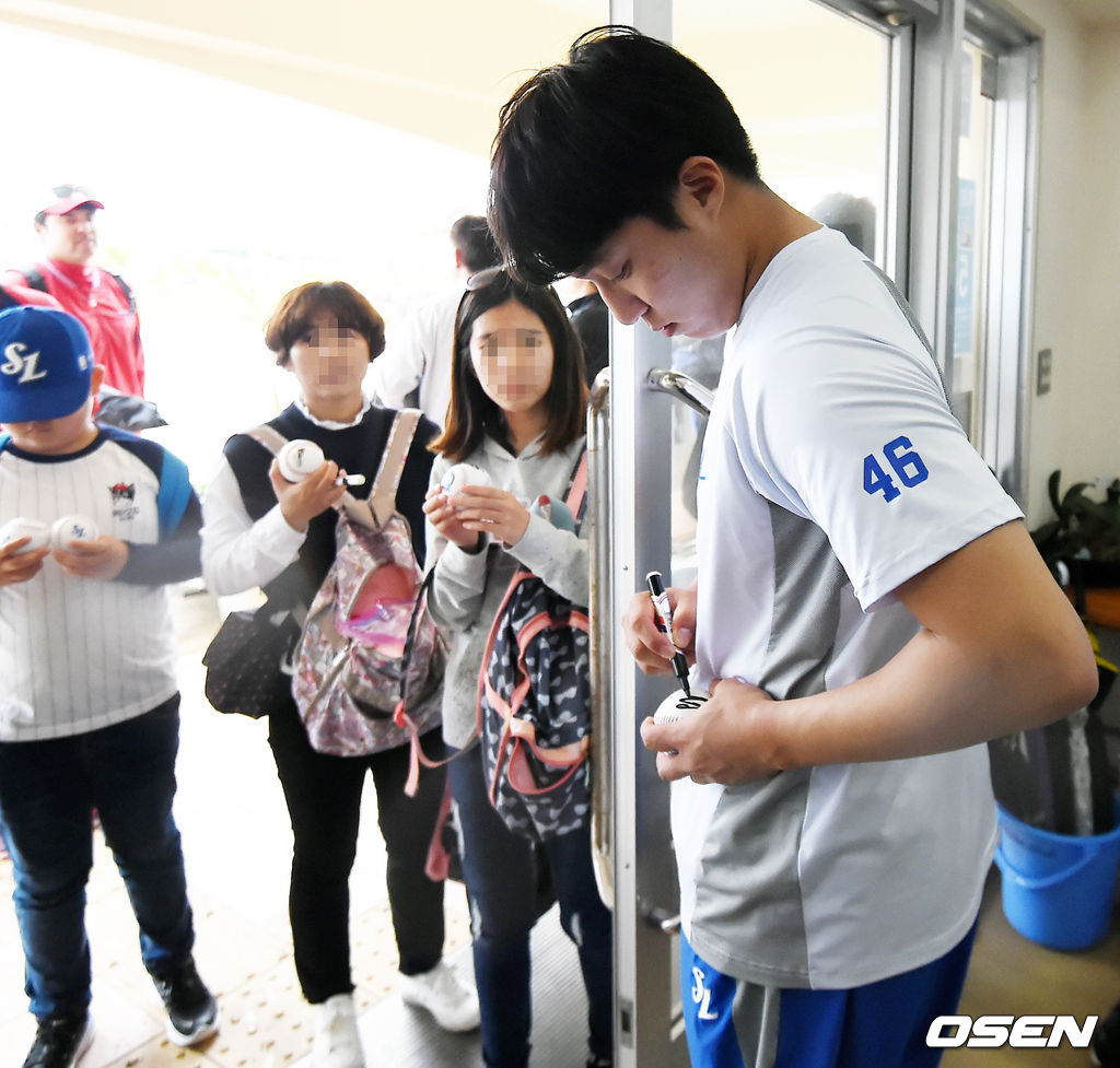 우천취소로 인해 삼성 선수들이 구장을 나설때 원태인이 팬들에게사인을 해주고 있다./rumi@osen.co.kr