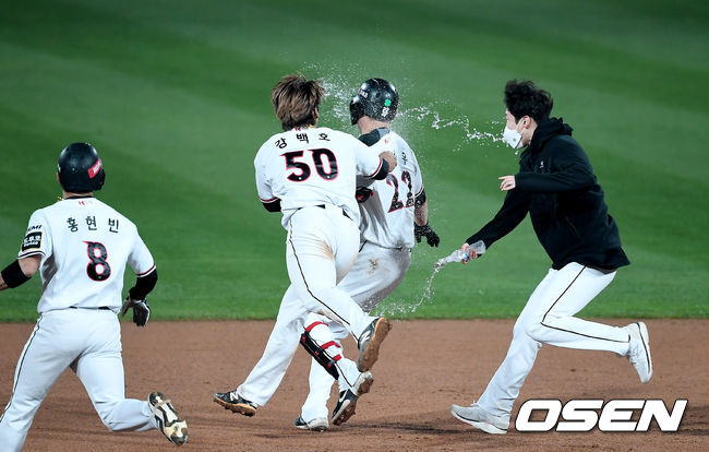 KT는 27일 수원KT위즈파크에서 열린 ‘2021 신한은행 SOL KBO리그’ SSG와 시즌 5차전에서 연장 10회 승부 끝에 6-5 승리를 거뒀다. 전날(26일) 연장 12회 접전 끝에 5-9로 패한 KT는 2연패 탈출 성공. 7연승을 노리던 SSG의 기세를 꺾었다.연장 10회말 1사 1,2루 끝내기 안타를 때린 KT 장성우가 동료들에게 축하를 받고 있다. 2021.05.27 /youngrae@osen.co.kr
