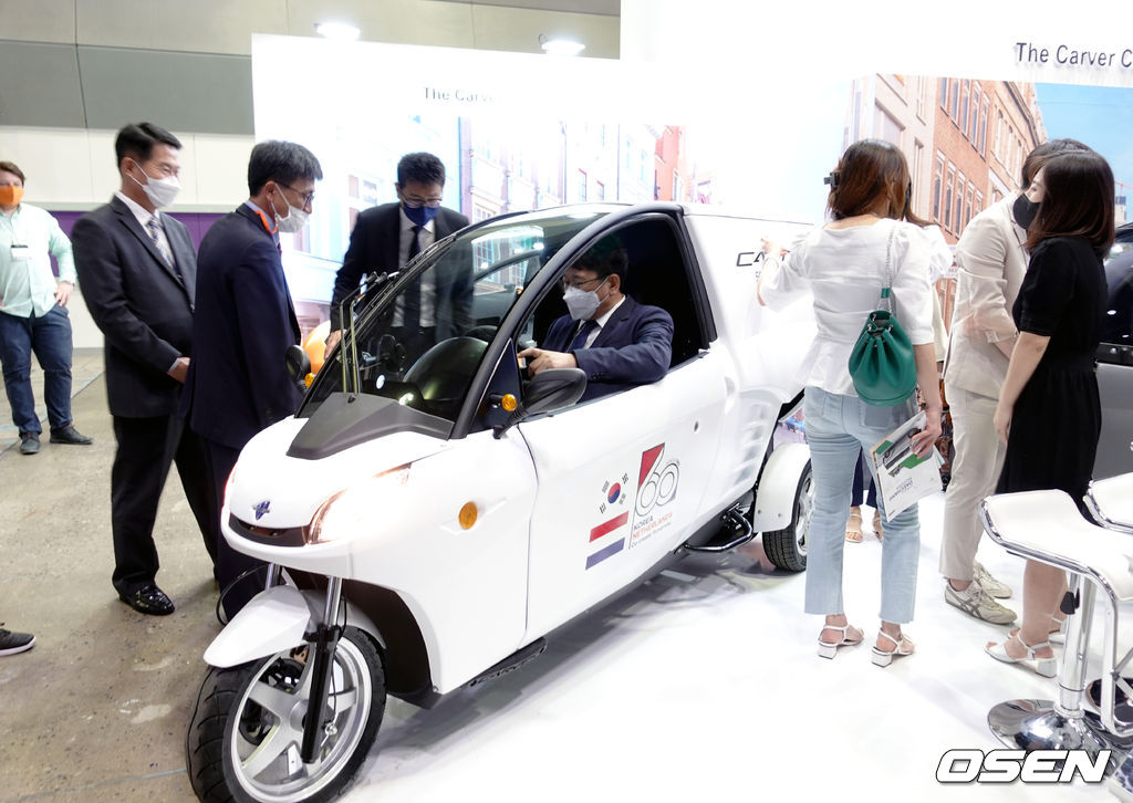 이동원 코엑스 대표이사가 도시형 전기자동차 (주)DSEV 부스에서 3륜 전기차 카버(Carver)에 탑승해보고 있다.