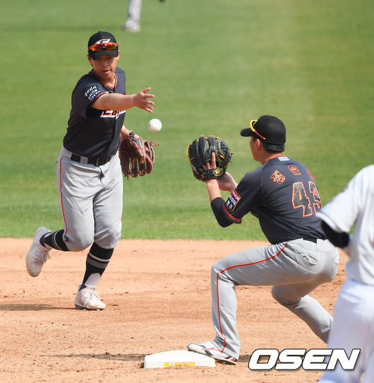 한화 노시환이 2루 베이스 커버를 들어온 정은원에게 토스를 하고 있다.
