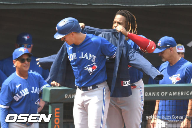 [사진] 토론토의 블라디미르 게레로 주니어가 13일(한국시간) 볼티모어와의 원정 경기 3회서 솔로 홈런을 친 제이크 램에게 홈런 재킷을 입혀주고 있다.ⓒGettyimages(무단전재 및 재배포 금지)