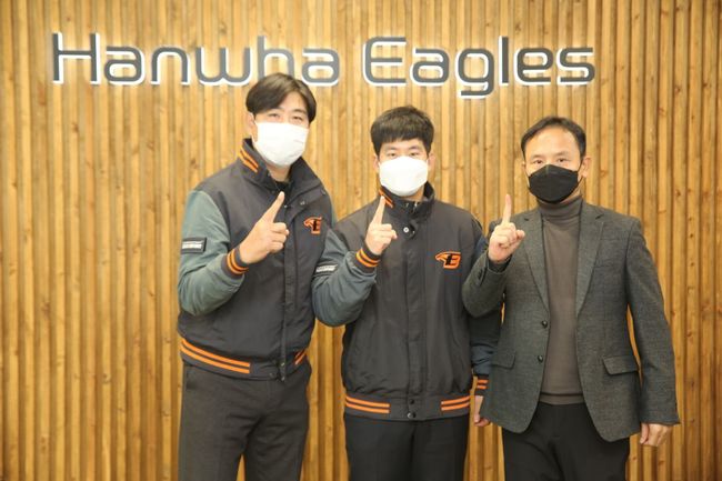 한화 정민철 단장, 최재훈, 에이전트 김현수 브랜뉴스포츠 대표(왼쪽부터)가 검지손가락을 들어 FA 1호 계약을 자축하고 있다. /한화 이글스 제공