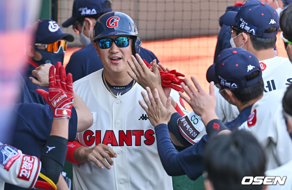 이대호가 5회말 무사 1,3루 고승민의 투수 앞 땅볼때 득점을 올리고 하이파이브를 하고 있다.