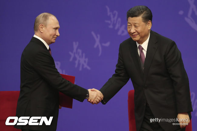 Russian President Vladimir Putin, left, shakes hands with Chinese President Xi Jinping, right, during the Tsinghua University’s ceremony, at Friendship palace in Beijing, China on April 26, 2019. (Kenzaburo Fukuhara/POOL/Kyodonews)