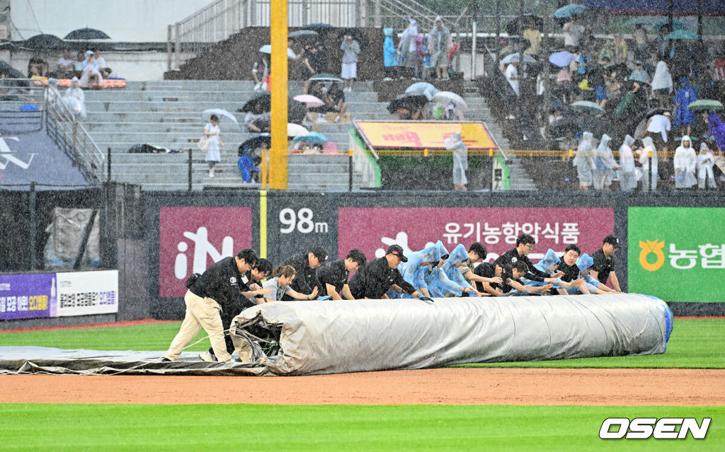 29일 오후 수원 KT위즈파크에서 ‘2024 신한 SOL Bank KBO리그’ KT 위즈와 삼성 라이온즈의 경기가 열렸다.이날 홈팀 KT는 엄상백, 원정팀 삼성은 백정현을 선발로 내세웠다.4회말 1사 주자 1루 KT 황재균 타석에서 폭우로 인해 경기가 우천 중단되며 방수포가 깔리고 있다. 2024.06.29 / rumi@osen.co.kr