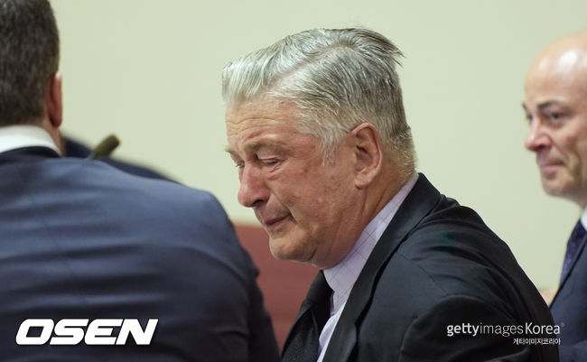 US actor Alec Baldwin reacts as he sits between his attorneys Alex Spiro (L) and Luke Nikas (R) at the conclusion of his trial on involuntary manslaughter at Santa Fe County District Court in Santa Fe, New Mexico, on July 12, 2024. Baldwin's trial for involuntary manslaughter was dismissed by a judge Friday after she ruled that key evidence over a fatal shooting on the set of "Rust" had been withheld from the defense. (Photo by Ramsay de Give / POOL / AFP)