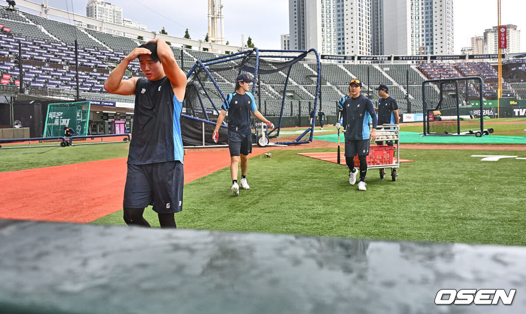 6일 부산 사직야구장에서 2024 신한 SOL 뱅크 KBO 리그 롯데 자이언츠와 NC 다이노스의 경기가 열린다. 홈팀 롯데는 윌커슨이 선발 출전하고 NC는 신민혁이 선발 출전한다.롯데 자이언츠 선수들이 훈련 중 갑자기 내린 소나기를 피하고 있다. 2024.08.06 / foto0307@osen.co.kr