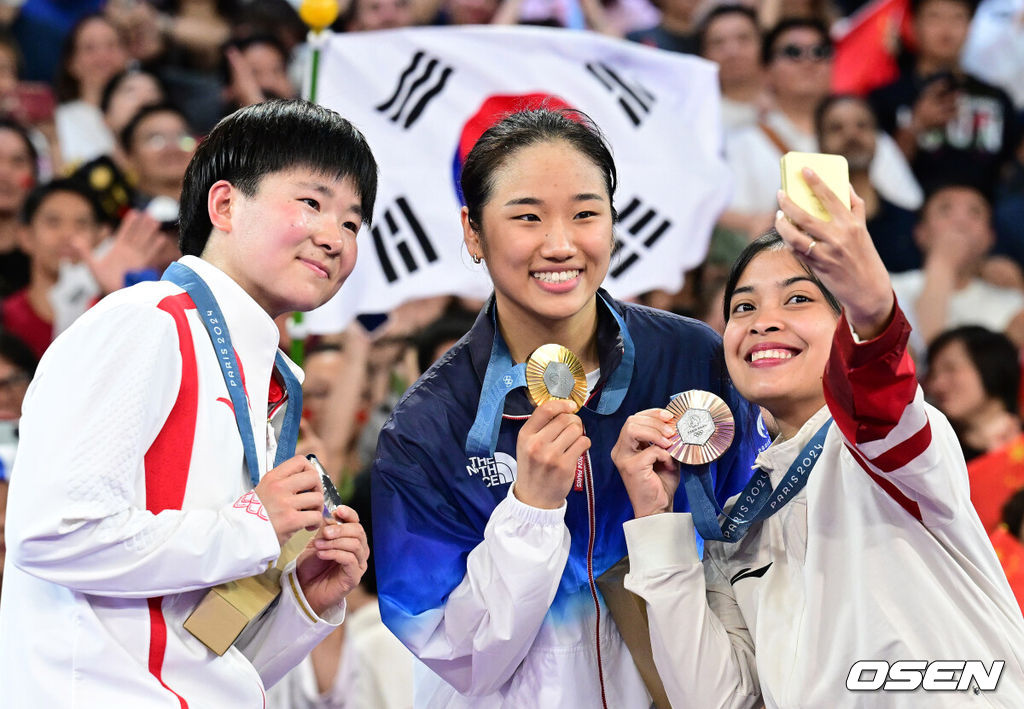 5일(한국시간) '셔틀콕 여제' 안세영(22, 삼성생명)이 꿈에 그리던 올림픽 금메달을 목에 걸었다.세계 랭킹 1위 안세영은 5일 오후(이하 한국시간) 프랑스 파리 포르트 드 라샤펠 경기장에서 열린 2024 파리올림픽 배드민턴 여자 단식 결승전에서 랭킹 9위 허빙자오(중국)를 2-0으로 꺾고 금메달을 획득 했다.  금메달 한국 안세영(가운데)와 은메달 중국 허빙자오(왼쪽), 동메달 인도네시아 툰중과 기념촬영을 하고 있다. 2024.08.05 / dreamer@osen.co.kr