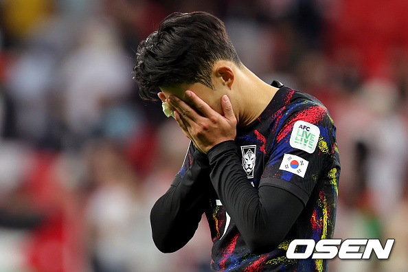 DOHA, QATAR - FEBRUARY 06: Son Heung-min of South Korea stands dejected after defeat following the AFC Asian Cup semi final match between Jordan and South Korea at Ahmad Bin Ali Stadium on February 06, 2024 in Doha, Qatar. (Photo by Lintao Zhang/Getty Images)