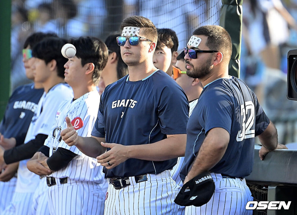 27일 부산 사직야구장에서 2025 신한 SOL 뱅크 KBO 리그 롯데 자이언츠와 KIA 타이거즈의 경기가 열렸다. 홈팀 롯데는 나균안이, 방문팀 KIA는 네일이 선발 출전했다.롯데 자이언츠 데이비슨과 감보아가 이마에 아이스 시트를 붙이고 더위를 식히고 있다. 2025.07.27 / foto0307@osen.co.kr