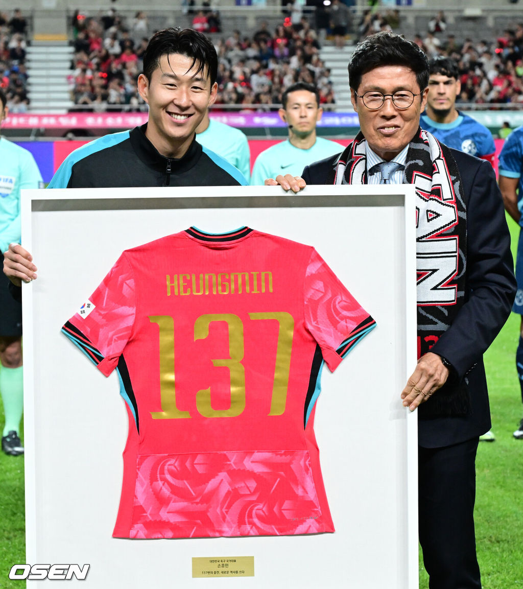 한국 축구가 안방에서 '남미 강호' 파라과이를 물리치며 사상 최초의 2026 국제축구연맹(FIFA) 북중미 월드컵 포트 2 확보에 청신호를 켰다.한국 축구대표팀은 14일 오후 8시 서울월드컵경기장에서 열린 A매치 친선 경기에서 파라과이를 2-0으로 제압했다. 지난 10일 일본 원정에서 2-2로 비기고 온 파라과이는 한국에 덜미를 잡히며 10월 아시아 투어를 1무 1패로 마감하게 됐다.경기 전 차범근 전 감독이 경기장을 찾아 손흥민에게 기념 유니폼을 직접 전달하고 있다. 2025.10.14 /cej@osen.co.kr
