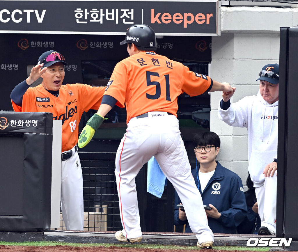 18일 오후 대전 한화생명볼파크에서 2025 신한 SOL Bank KBO리그 포스트시즌 플레이오프 1차전 한화 이글스와 삼성 라이온즈의 경기가 열렸다.한화는 폰세, 삼성은 가라비토를 선발 투수로 내세웠다.2회말 역전 3타점 적시타를 친 문현빈이 노시환의 적시타때 득점을 올리고 김경문 감독의 환영을 받고 있다. 2025.10.18 /spjj@osen.co.kr