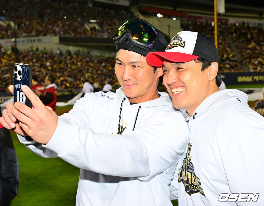 1일 오후 서울 잠실야구장에서  LG 트윈스의 한국시리즈 통합우승 IN 잠실' 행사가 열렸다.팬들을 위한 트로피 퍼포먼스, 선수단 그라운드 행진, 비하인드 스몰토크, 선수단 샴페인 샤워 등 다양한 프로그램이 펼쳐진다.잠실구장 그라운드 위에서 LG 오지환과 박동원이 기념 사진을 찍고 있다. 2025.11.01 /rumi@osen.co.kr