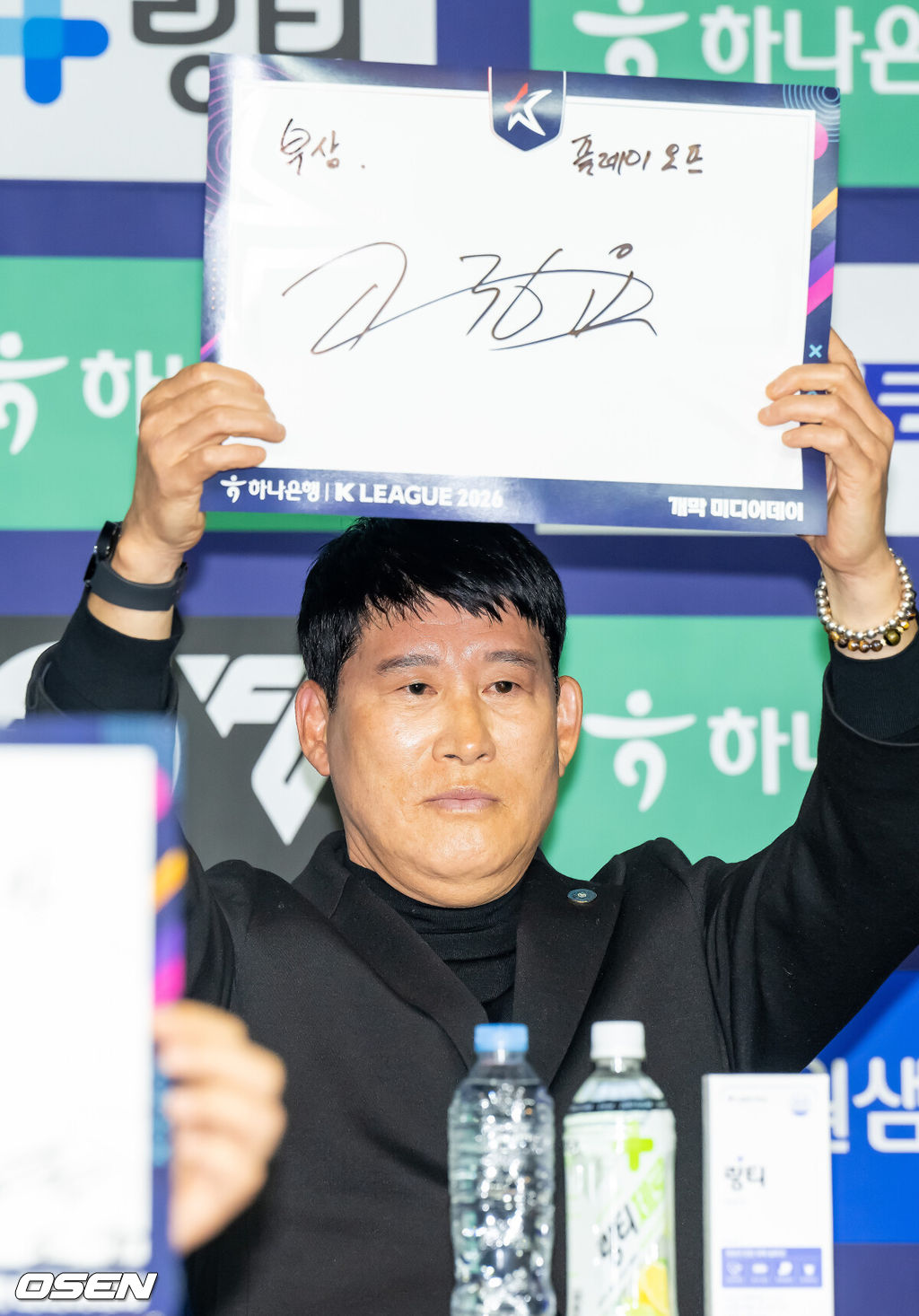 25일 서울 서대문구 스위스그랜드 호텔 컨벤션센터에서 하나은행 K리그 2026 개막 미디어데이(2부 K리그2)가 진행됐다.프로축구 K리그 29개 구단이 새 시즌 개막을 앞두고 저마다 당찬 출사표를 던졌다. 출사표를 적어달라는 사회자의 요청에 김포 고정운 감독이 자신의 이름을 들어보이고 있다. 2026.02.25 / soul1014@osen.co.kr