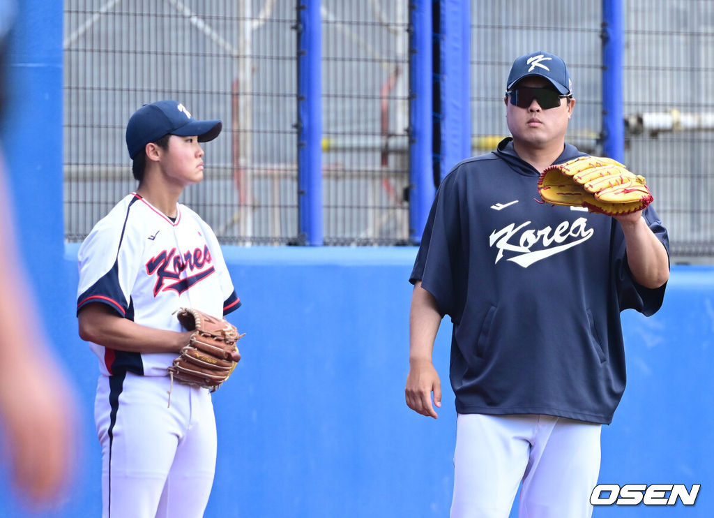 2026 WBC(월드베이스볼클래식)를 준비하는 대한민국 야구 대표팀이 26일 일본 오키나와 가데나 야구장에서 프로야구 삼성 라이온즈와 연습경기를 펼쳤다. 야구 대표팀은 오키나와에서 국내 팀들과 6차례 연습경기를 치르며 전력을 끌어올릴 예정이다.4회말 공격 때 대표팀 류현진이 몸푸는 정우주 옆에서 파울 타구를 막아주고 있다. 2026.02.26 / dreamer@osen.co.kr