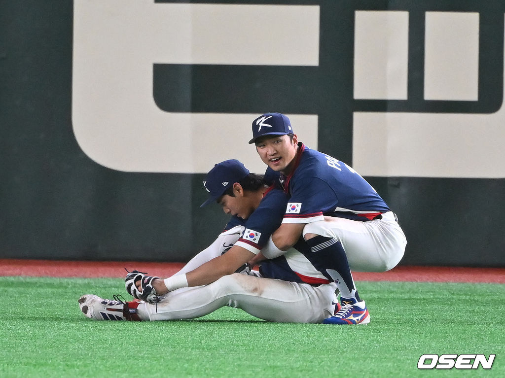  박해민이 긴장감에 주저앉은 이정후를 일으켜 세우고 있다.​