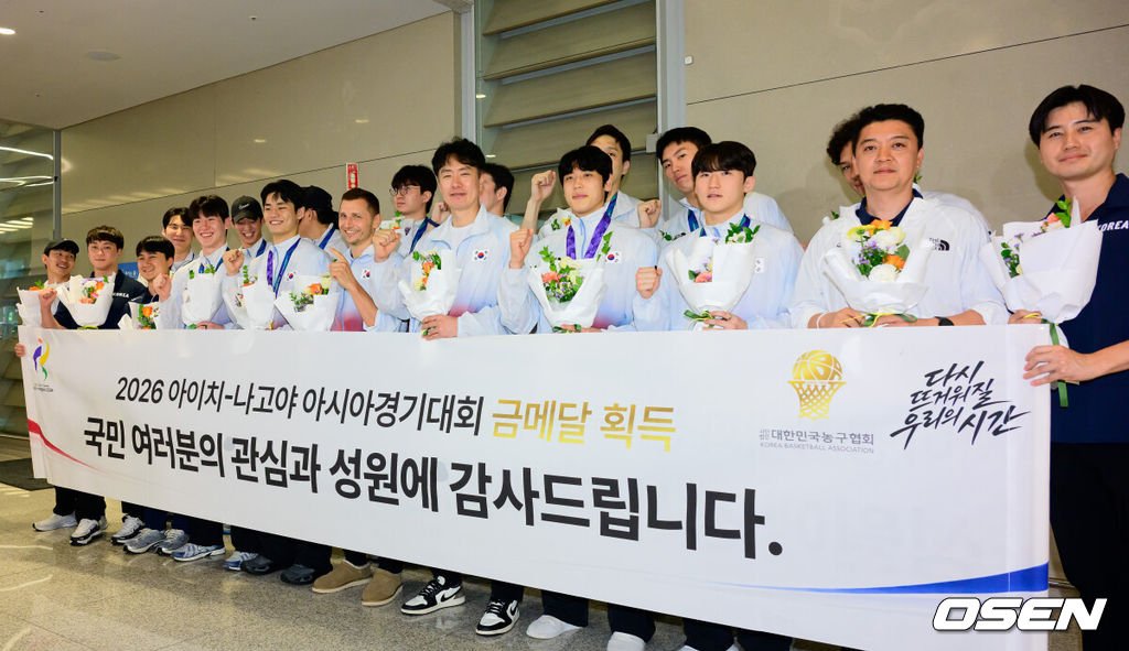 2026 아이치-나고야 아시안게임에서 금메달을 획득한 대한민국 남자농구대표팀이 21일 인천국제공항을 통해 입국했다.니콜라이스 마줄스 감독이 이끄는 대한민국 남자농구대표팀은 20일 일본 나고야 IG 아레나에서 열린 2026 아이치·나고야 아시안게임 남자농구 결승에서 개최국 일본을 65-57로 꺾었다. 2014 인천 아시안게임 이후 12년 만의 정상 탈환이다. 한국은 아시안게임 역사상 처음으로 성사된 남자농구 결승 한일전에서 개최국 일본을 제압하며 통산 다섯 번째 금메달을 목에 걸었다.농구대표팀 선수단이 포즈를 취하고 있다. 2026.09.21 / jpnews@osen.co.kr
