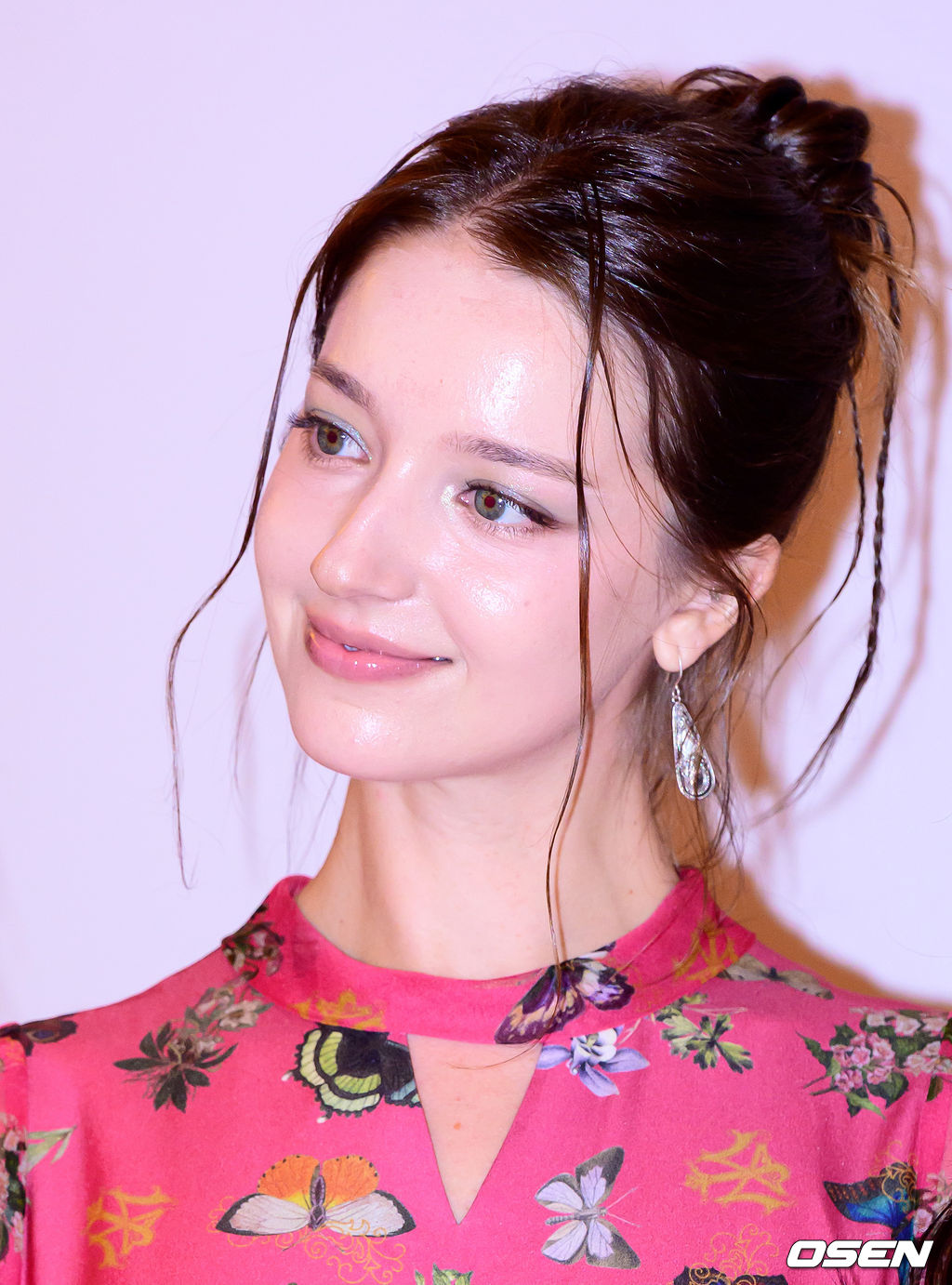 Angelina Danilova at the charity fashion show in a pink floral dress